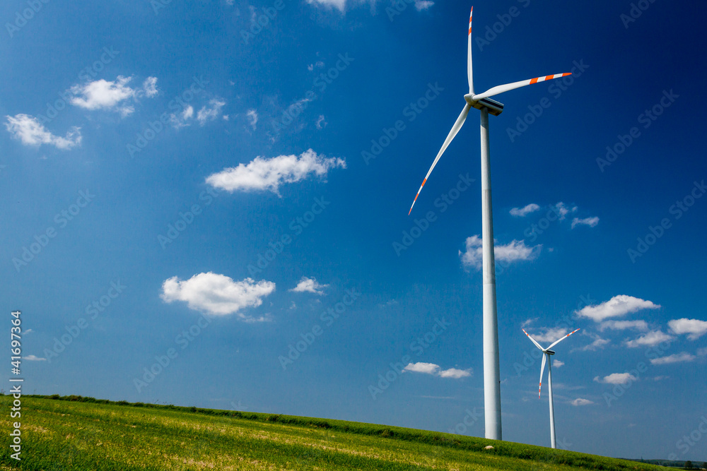 Alternative energy wind turbines on green field