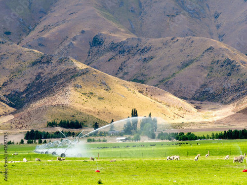 Irrigating lush farm pastures in central Otago, NZ photo