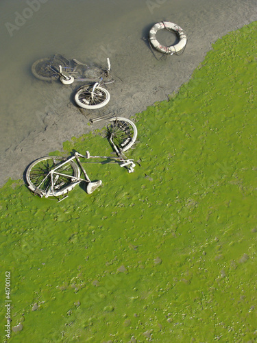 dried up green river bed reveals muddy bicycle