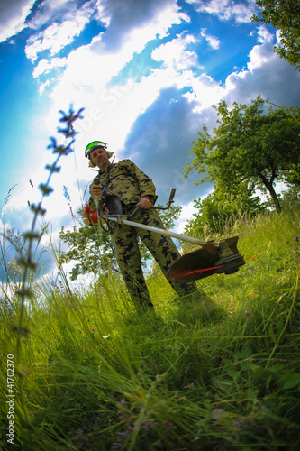 man with lawn trimmer photo