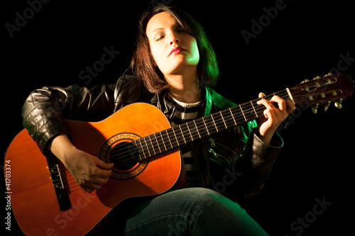 Woman Playing Classical Guitar in a Concert