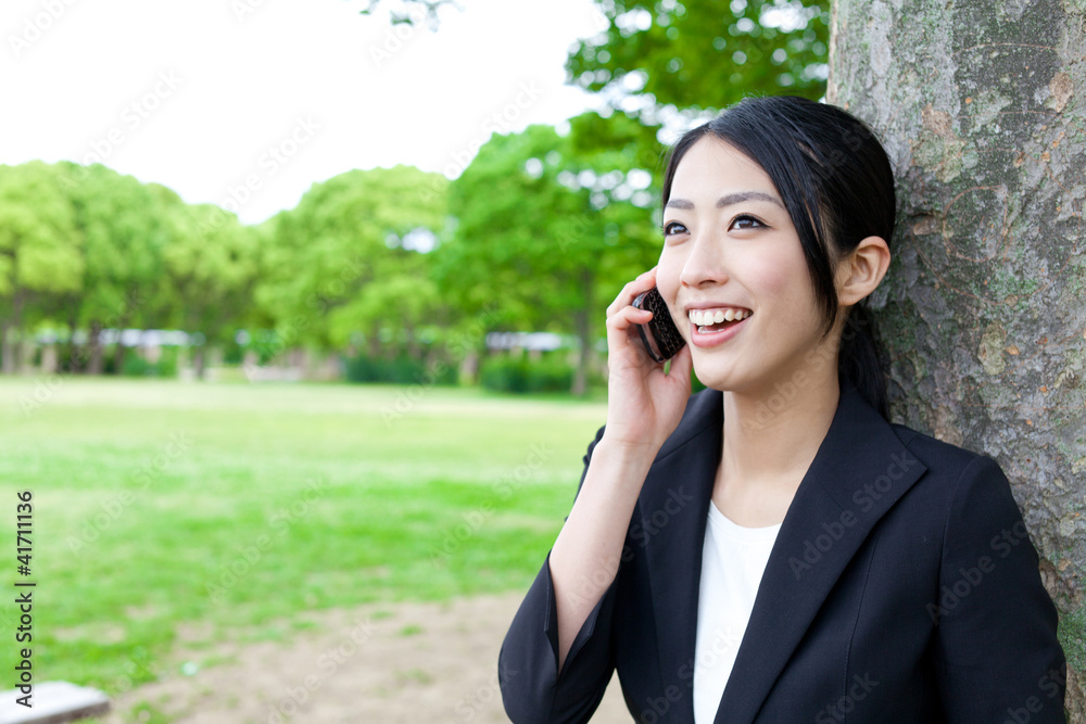 asian businesswoman talking in the park asian businesswoman talking in the park
