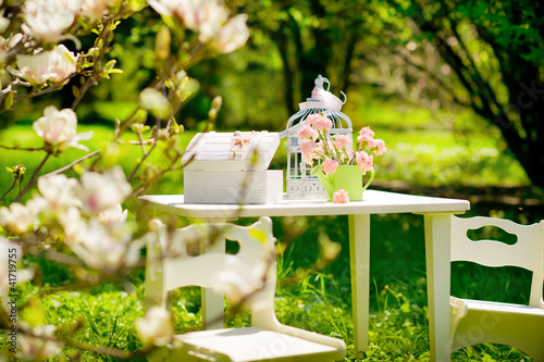 Table with chairs in a beautiful blooming garden