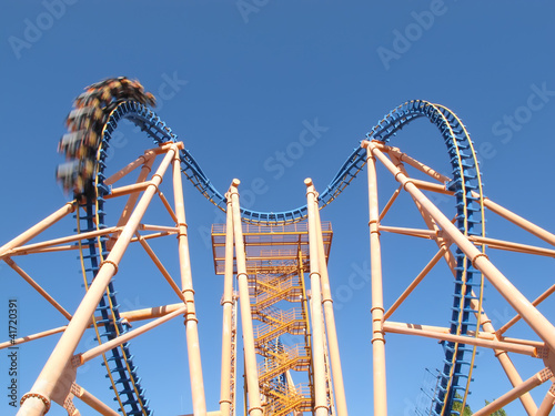 moving roller coaster with blue sky