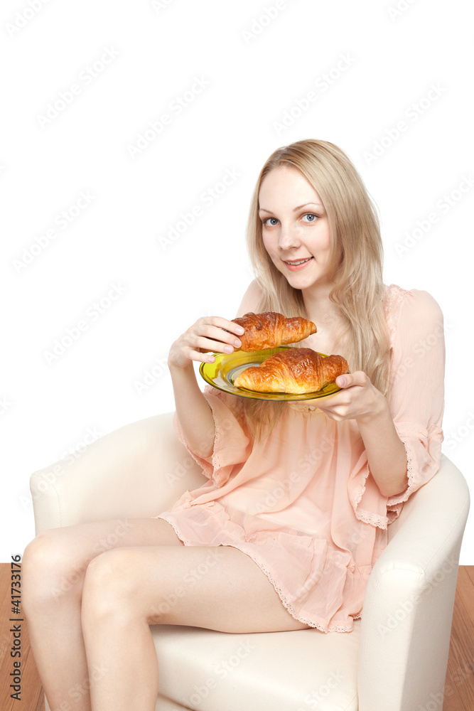 Beautiful healthy woman with croissant