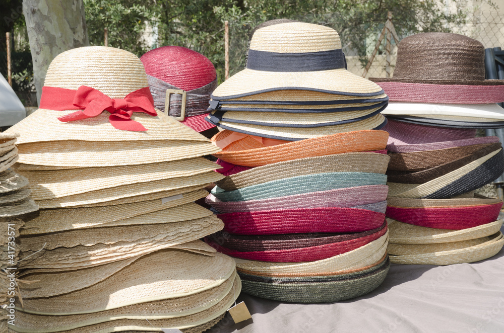 straw hats stacked on the market