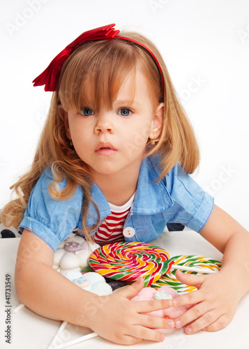 Konstfotografi Greedy  girl with pile of sweets