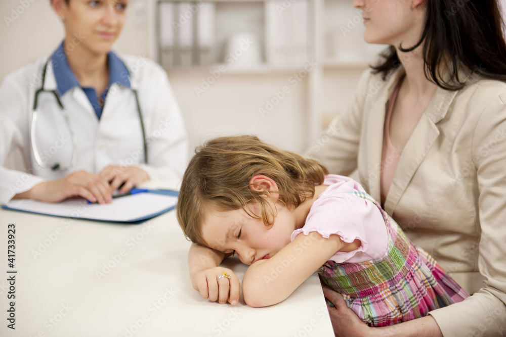 Pediatrician talking to mother and sick child Pediatrician talking to mother and sick child