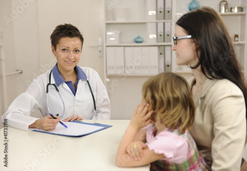 Pediatrician talking to mother and child