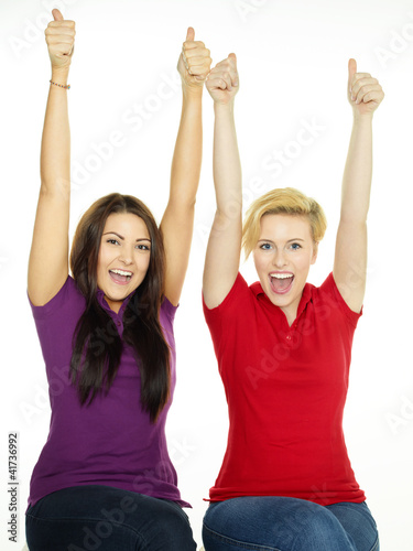 Two successful girls showing thumbs up