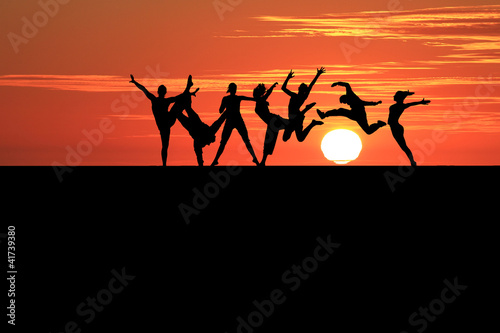 silhouette of gymnasts in sunset
