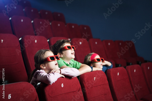 Excited kids watching cartoon in the 3D movie theater