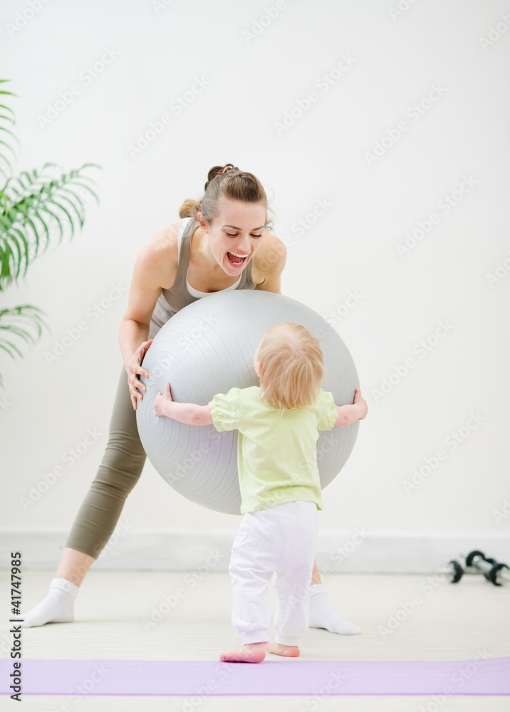 Mom and baby playing with fitness ball Mom and baby playing with fitness ball
