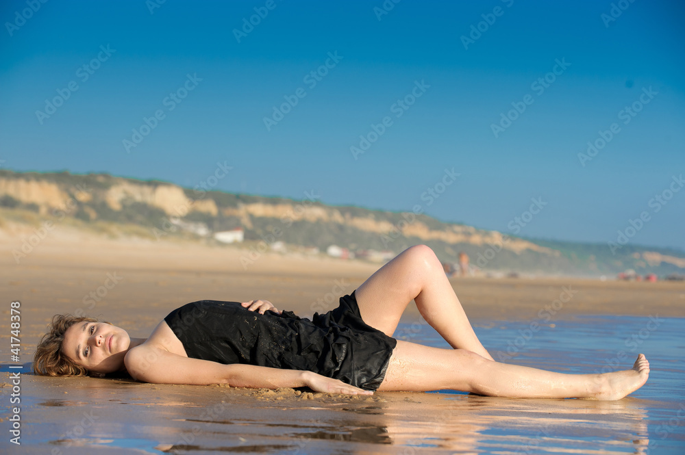 beautiful woman layed on the snad at the beach beautiful woman layed on the snad at the beach