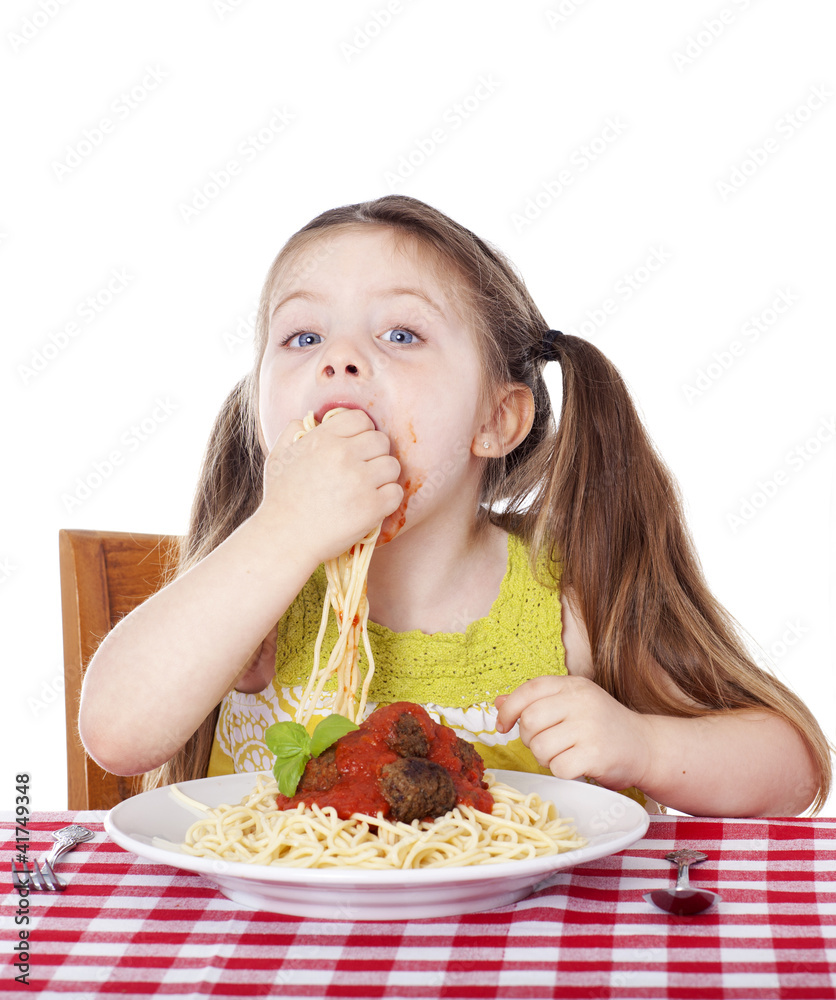 Beautiful girl eating pasta and meatballs with hands Beautiful girl eating pasta and meatballs with hands