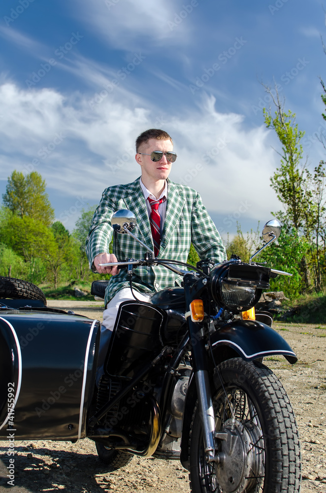 Classy guy on a motorcycle with a sidecar