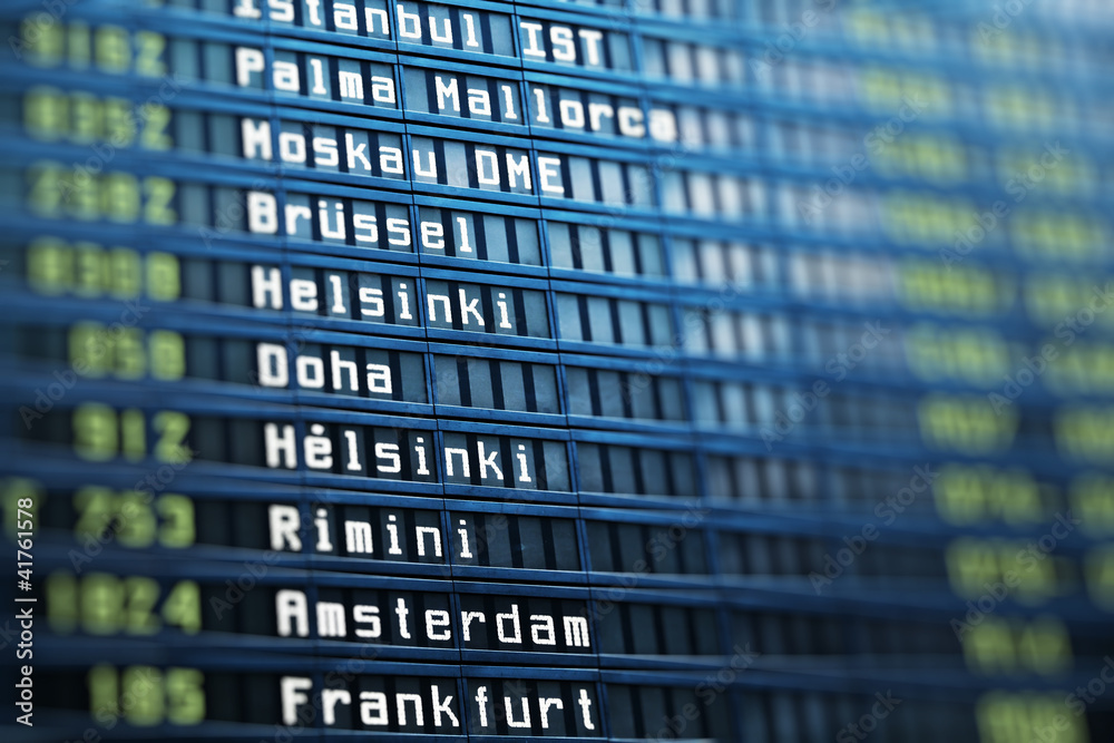 Flights information board in airport terminal Flights information board in airport terminal