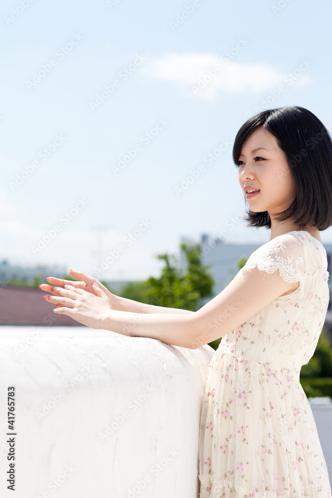 Beautiful young woman outdoors over blue sky Beautiful young woman outdoors over blue sky