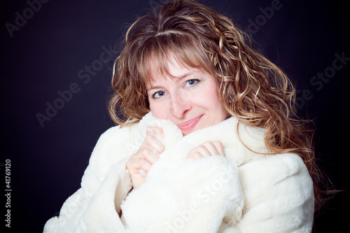 Fototapeta young woman with long curly hair white pelisse