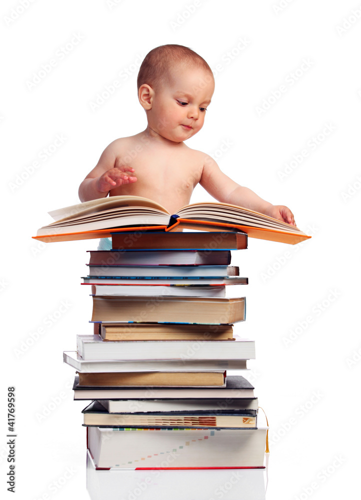 Portrait of a little boy standing behind a stack of books Portrait of a little boy standing behind a stack of books