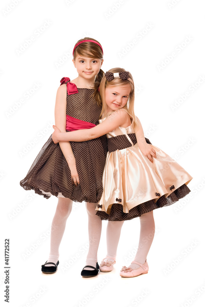Two cute little girls in a dress. Isolated Two cute little girls in a dress. Isolated