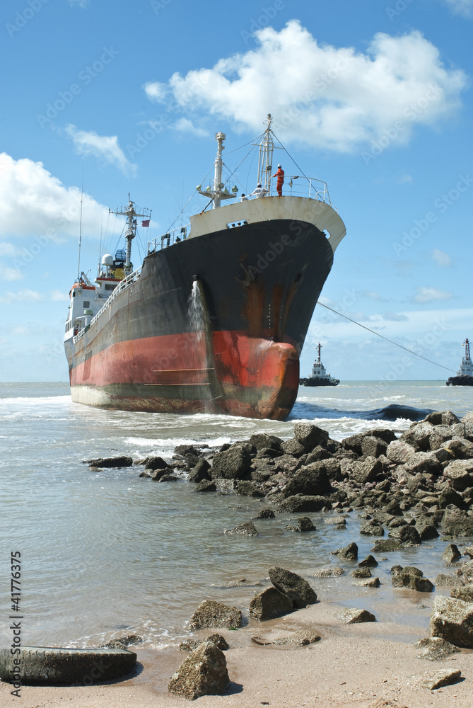 Cargo ship run aground on rocky shore