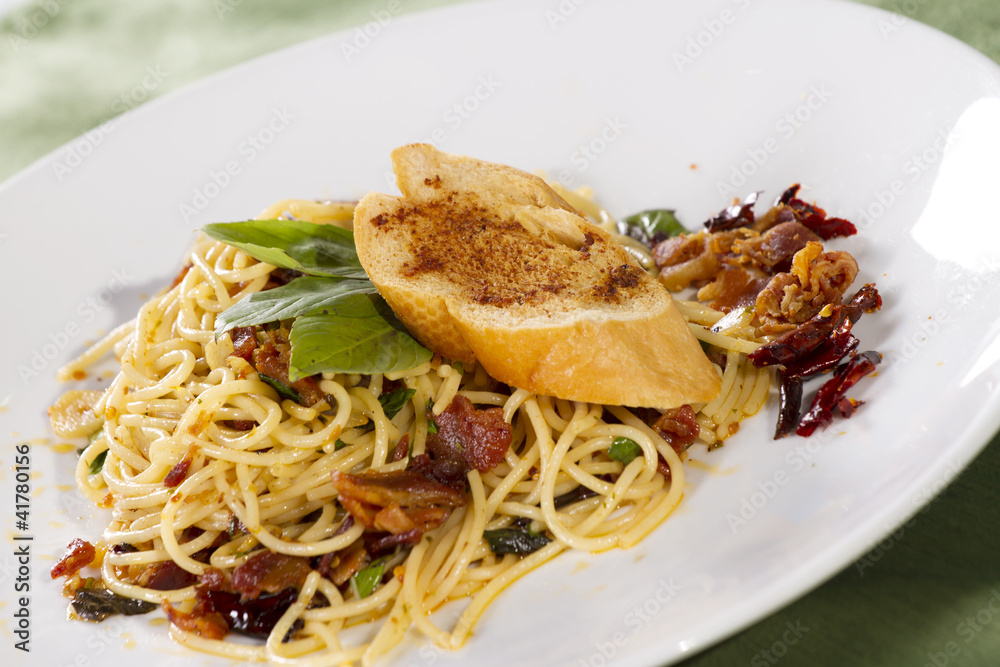 saute pasta with dried chili and piece of bread on top saute pasta with dried chili and piece of bread on top