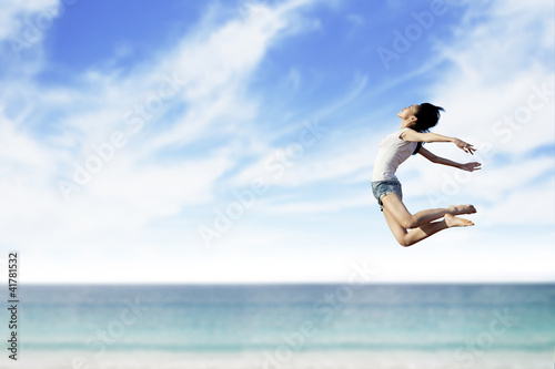 Woman flying at the beach