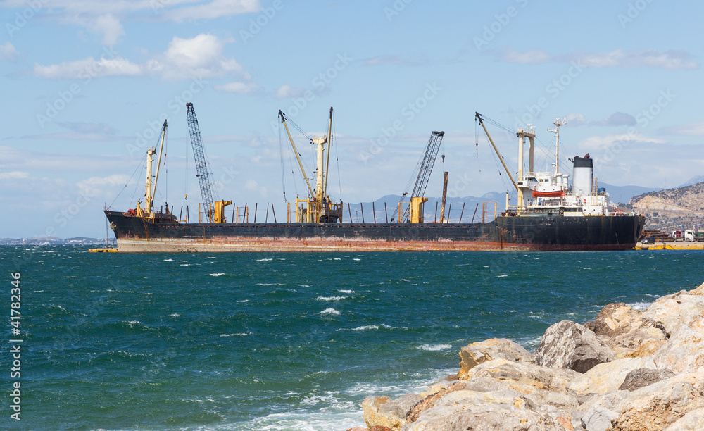 A bulk carrier ship loading cargo at port