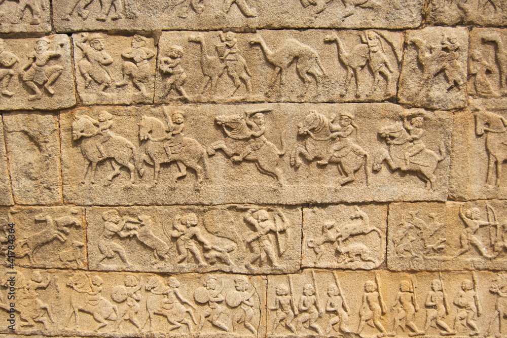 carving on ancient wall in hapi, india