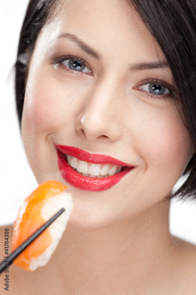 Young woman holding sushi with a chopsticks, closeup Young woman holding sushi with a chopsticks, closeup