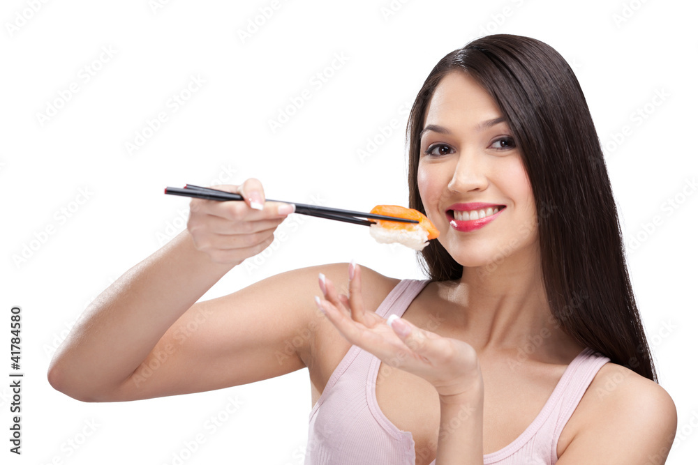 Brunette woman eating sushi with a chopsticks, isolated Brunette woman eating sushi with a chopsticks, isolated