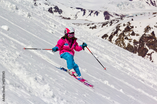 Girl on skis in the mountains