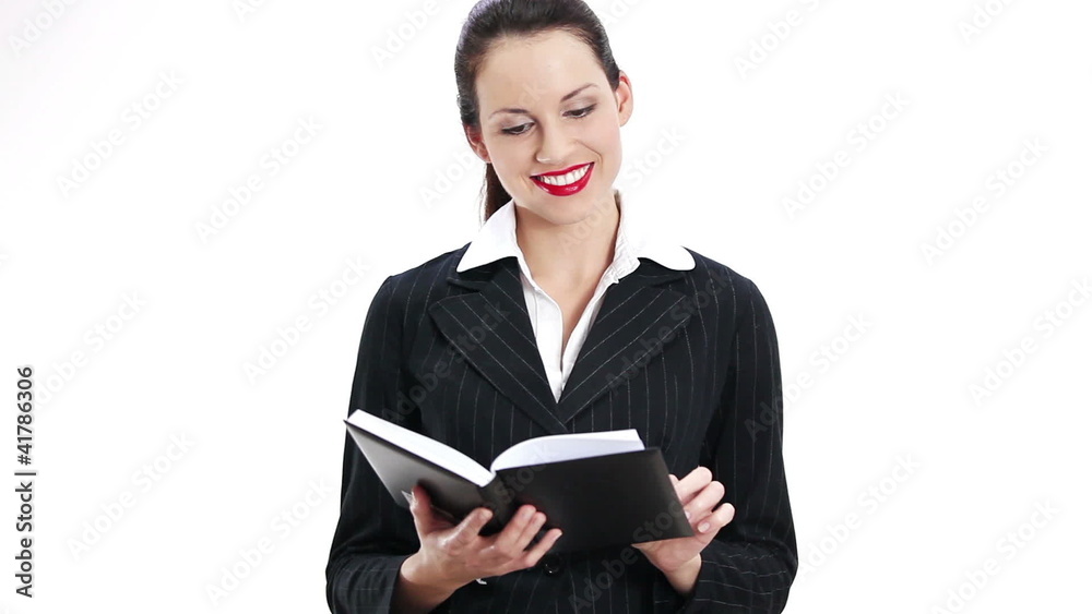 Businesswoman reading her notepad, over white background Businesswoman reading her notepad, over white background