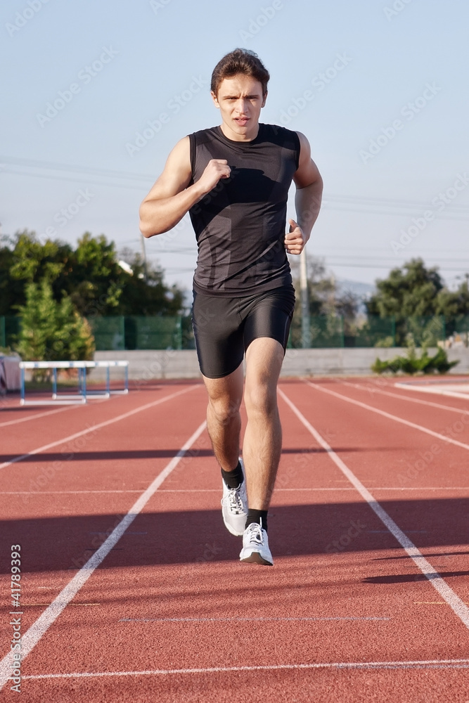 A young man run a hundred meters on the treadmill.