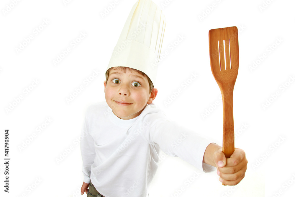 The boy holding a Spatula. Isolated on white background The boy holding a Spatula. Isolated on white background