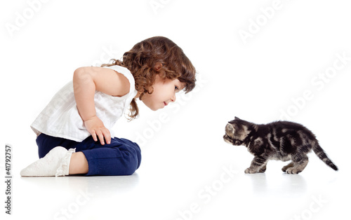 little kid and cat looking at each other on white background