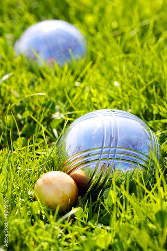 The bocce balls on a green grass.