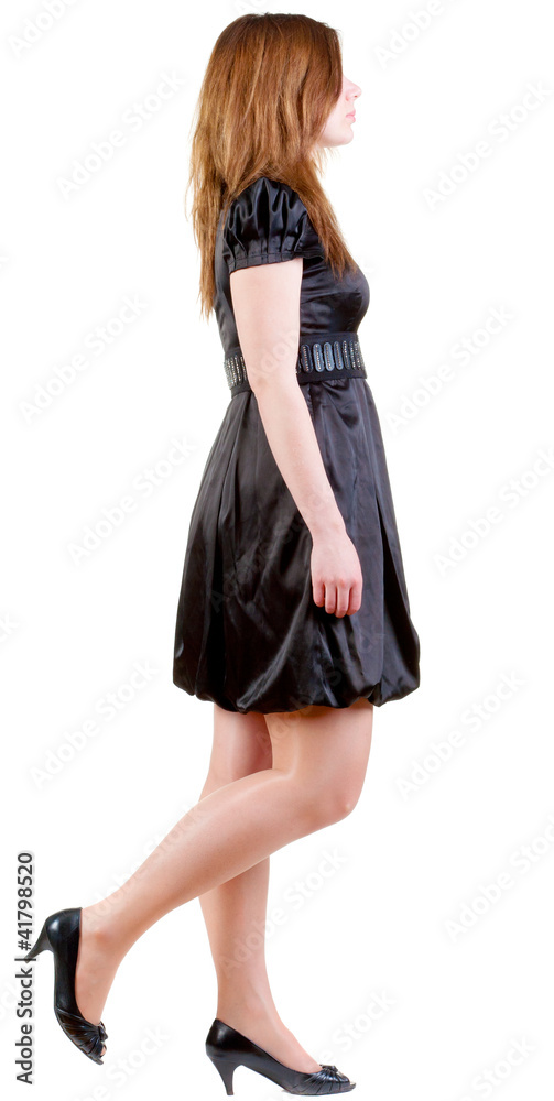 back view of walking  brunette woman