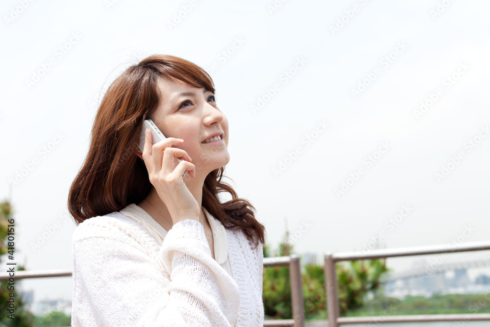 Beautiful young woman using a mobile phone Beautiful young woman using a mobile phone