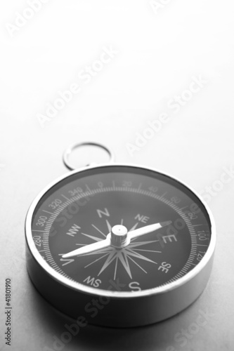 Compass on a gray gradient background, place for text