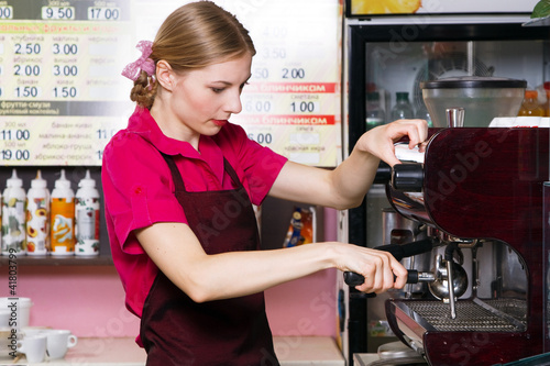 Friendly waitress making coffee