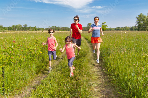Family sport, jogging. Happy active parents with kids run