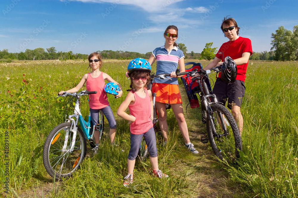 Happy family on bikes, cycling outdoors. Family sport Happy family on bikes, cycling outdoors. Family sport