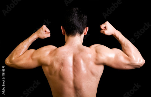 muscular male back on black background.