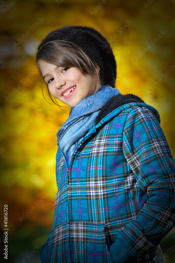 portrait of pretty teen girl in autumn park .Smiling girl