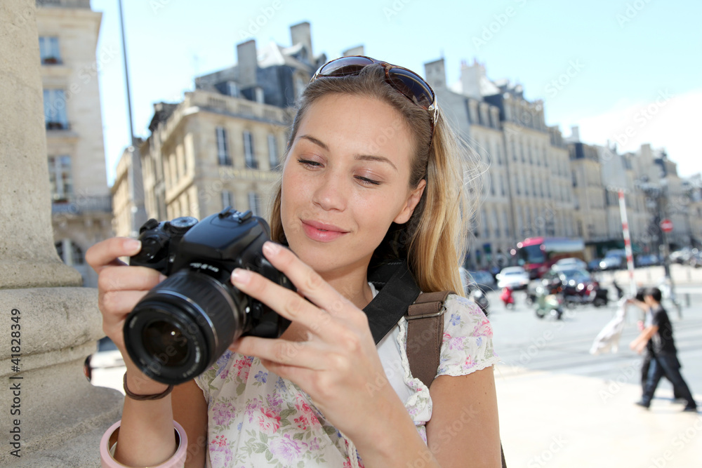 Portrait of young tourist looking at camera screen Portrait of young tourist looking at camera screen