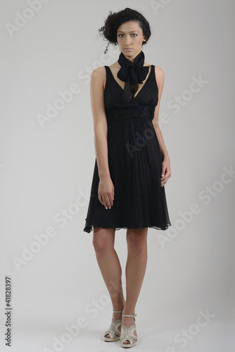 elegant woman in fashionable dress posing in the studio