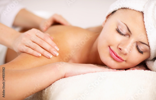 An attractive woman getting spa treatment, isolated on white