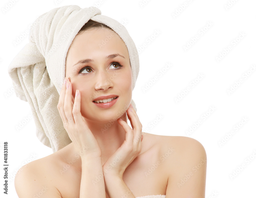 A beautiful young woman touching her face, looking up A beautiful young woman touching her face, looking up